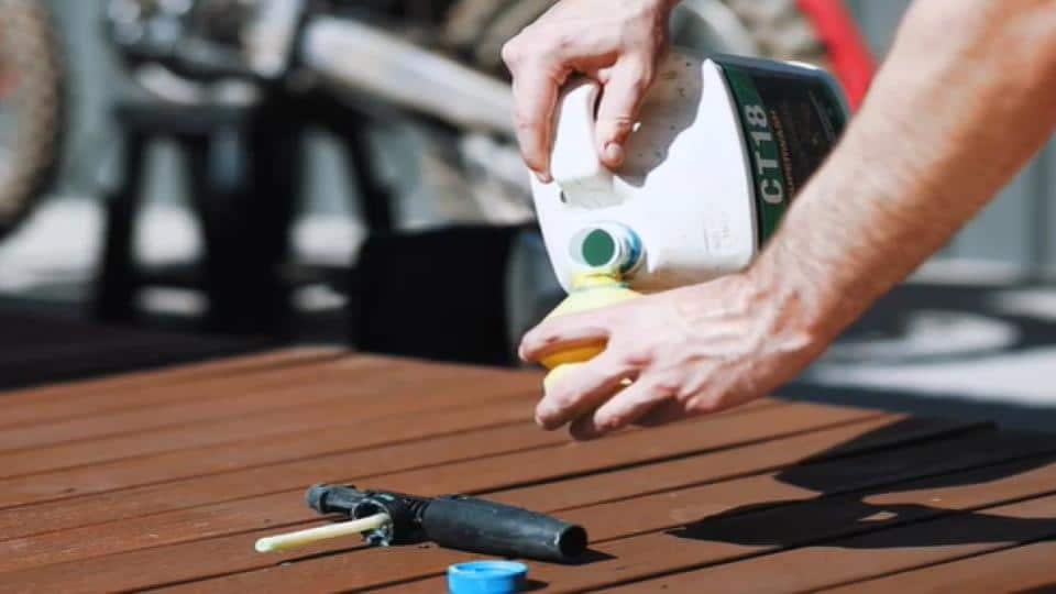 dirt bike cleaner pouring on spray cannister