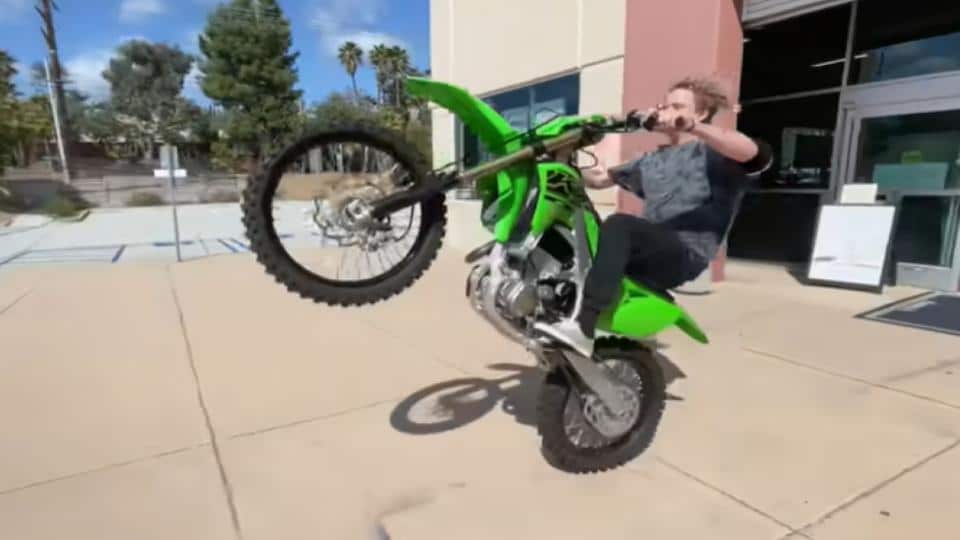 boy doing motocross stunt on the street