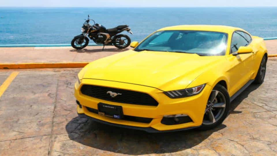 car and motorcycle with ocean view