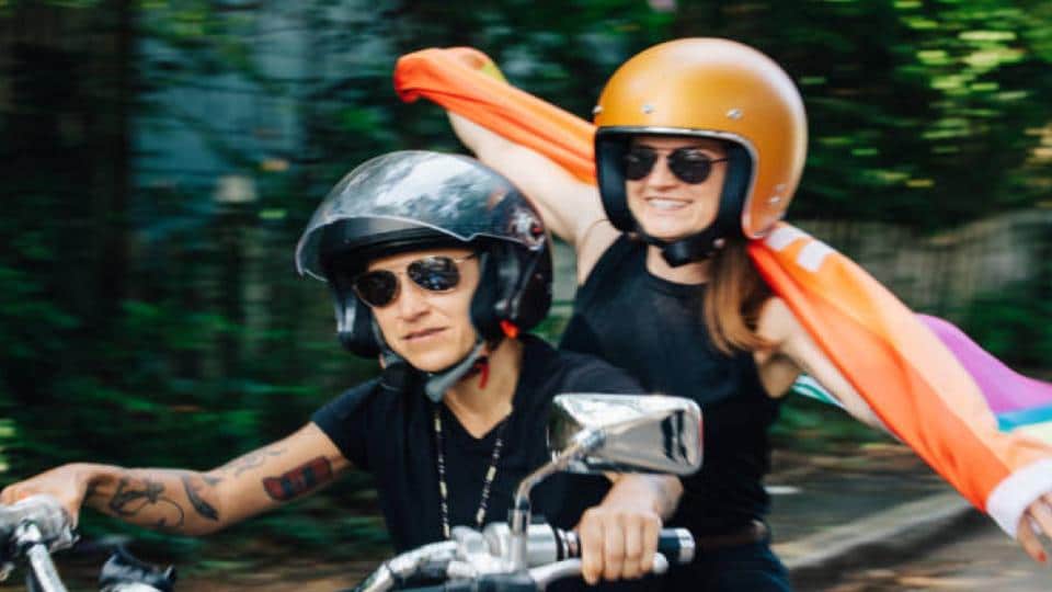 couple wearing a motorcycle helmet