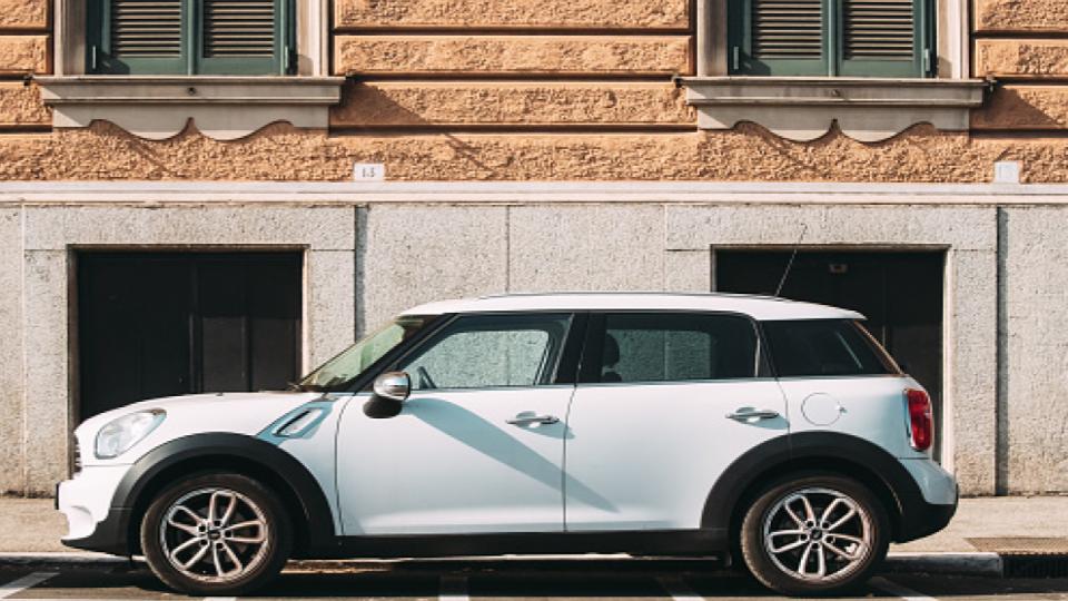 small white car parked on the street