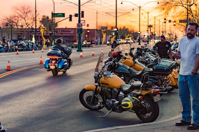 group of motorcycle riders in a city